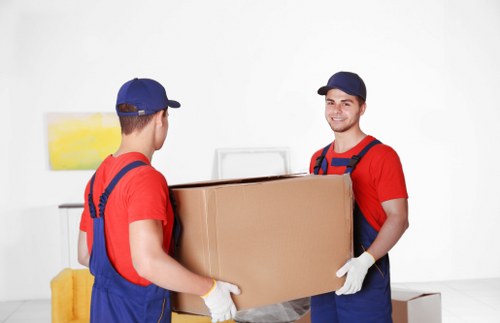 Professional movers preparing fragile items and furniture for transport