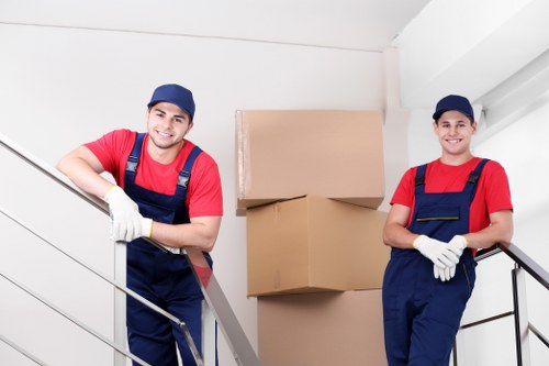 Removals team planning a home move in Queens Park with boxes and furniture