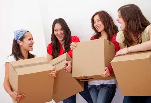 Office desks and chairs being moved carefully for a workplace relocation